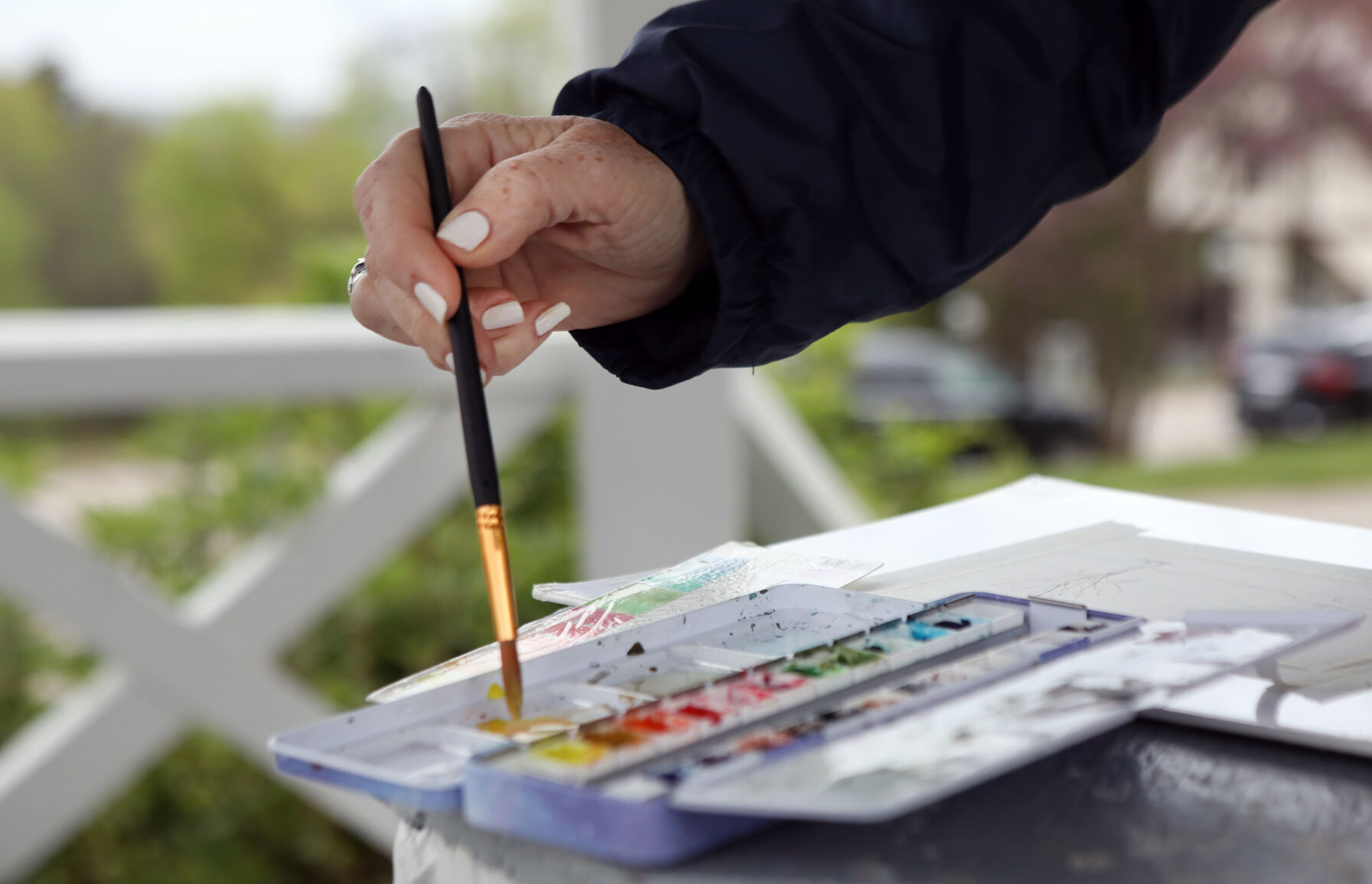 Antoinette Elgin dips her brush in watercolor